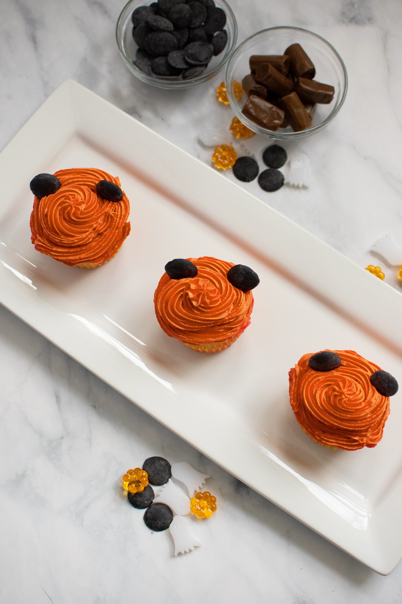 Putting the ears on your Mickey Pumpkin Cupcakes