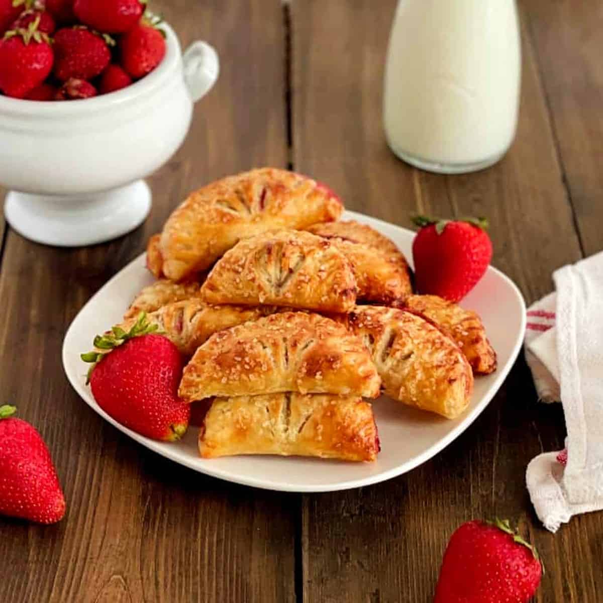 strawberry turnovers on a table with milk 1