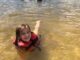 young child swimming at White Sands Day Lake Beach in Covington, Louisiana