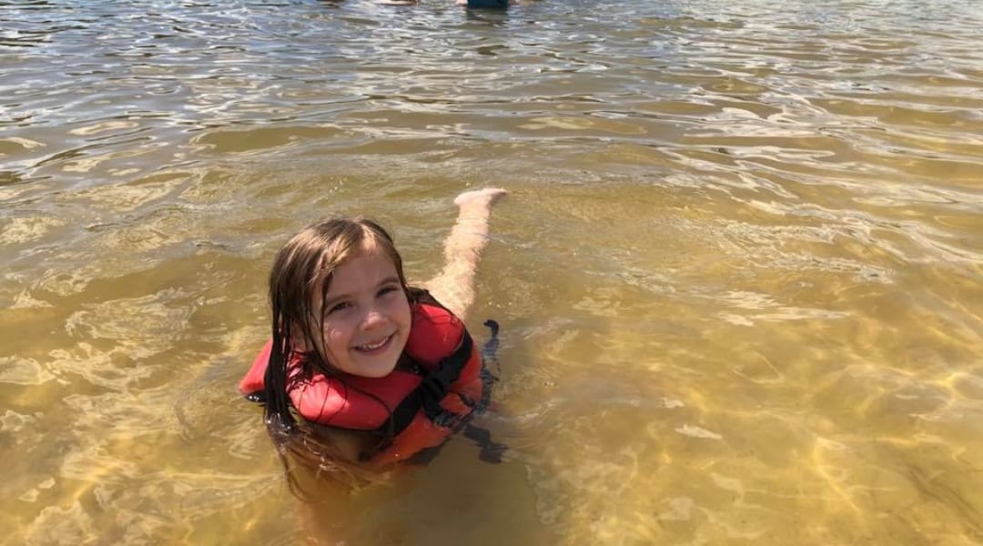 young child swimming at White Sands Day Lake Beach in Covington, Louisiana