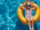 Little girl in a yellow float cooling off in a pool in New Orleans